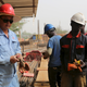 Chinese and Niger construction workers work on the site of an Islamic university in Niamey, Niger, in Feb. 2016.